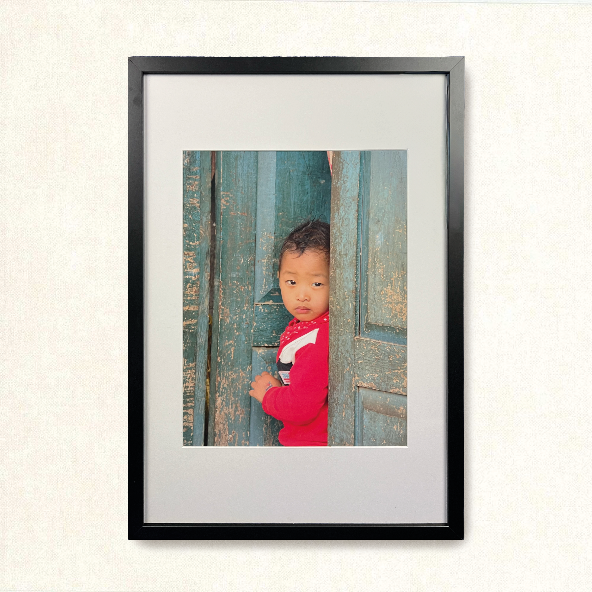 Red kid in blue door